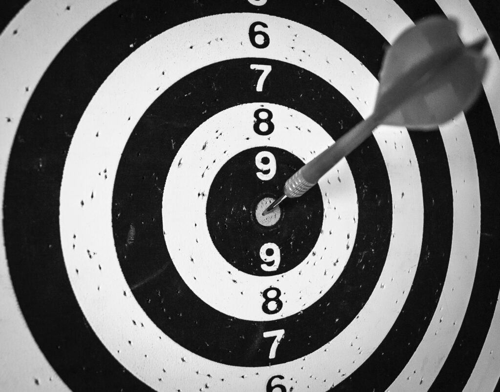 black and white target with dart on it