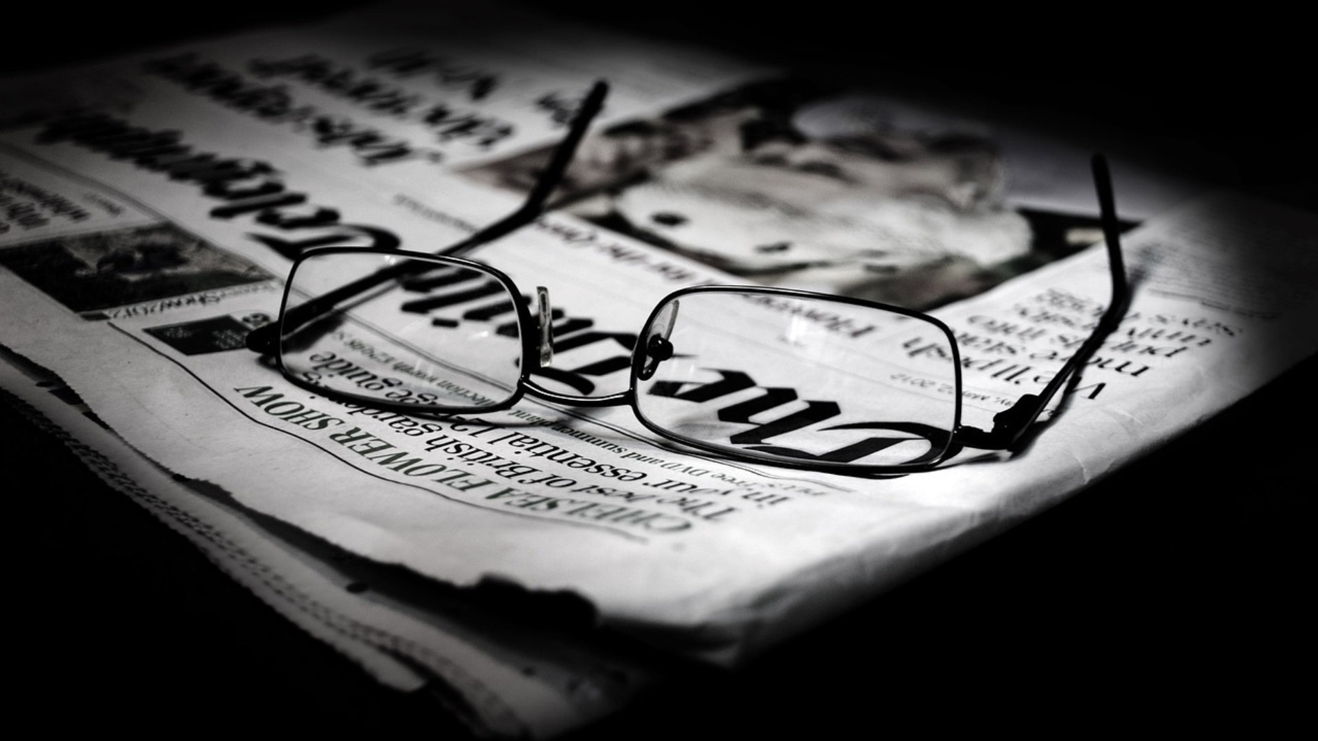 glasses on headline on newspaper